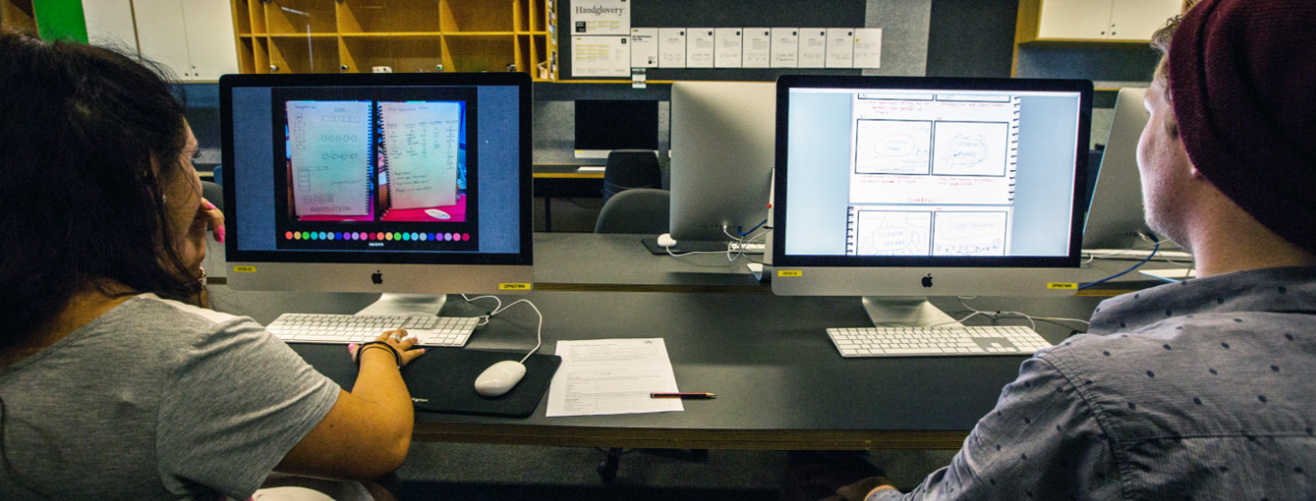 Campus couple designing in computer lab