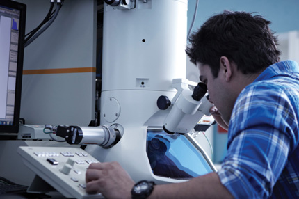 Campus male caucasian working with microscope